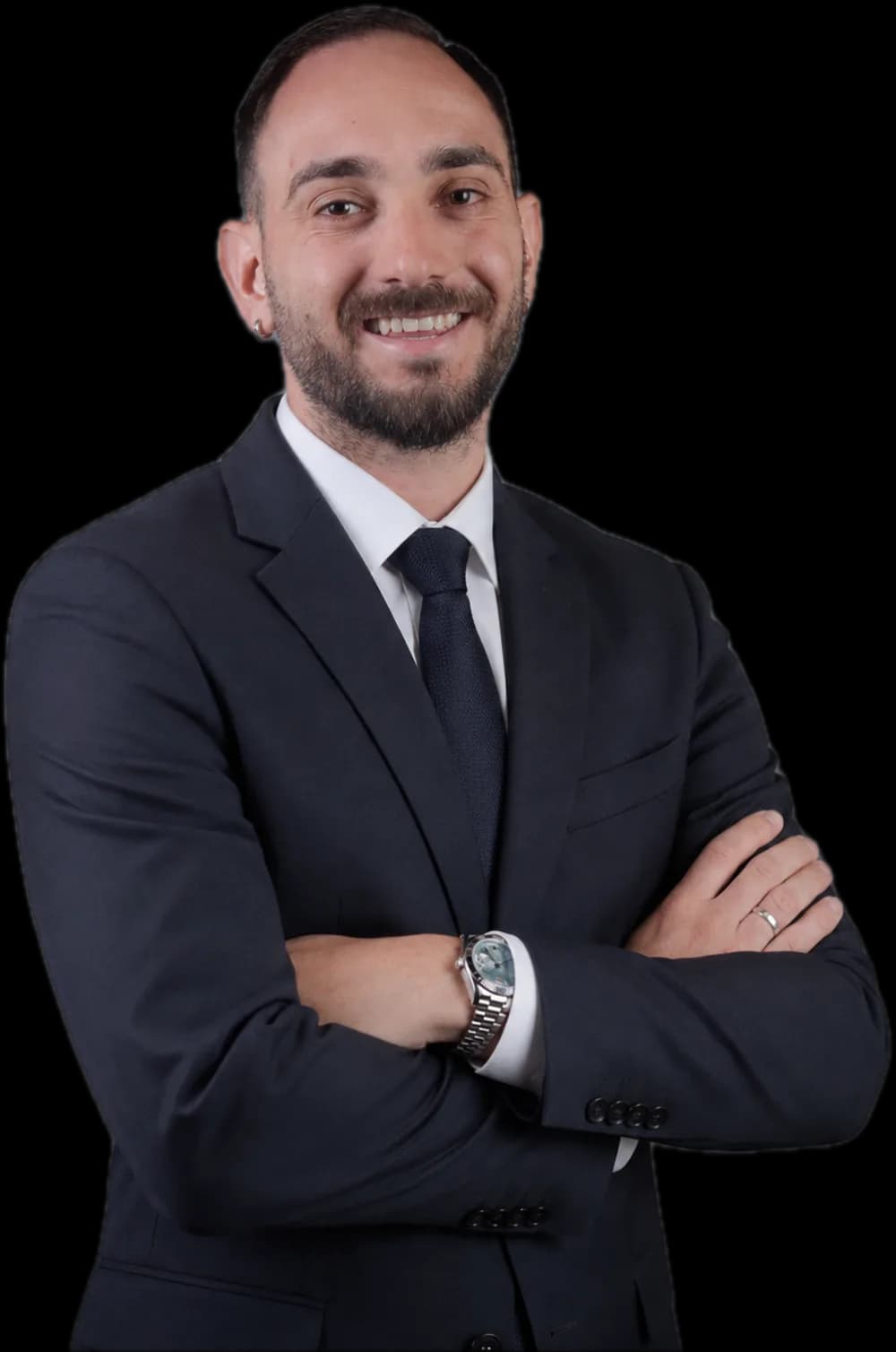 Gabriel Domínguez Torres in a dark suit with arms crossed, smiling